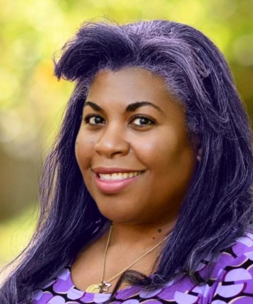 Beautiful Afro-Caribbean woman with long purple hair outdoors wearing a purple dress